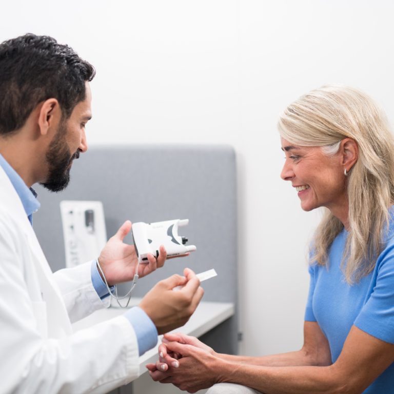 eye doctor preparing to check the eye pressure of a patient using an ocular tonometer